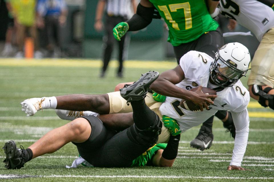 Oregon outside linebacker Teitum Tuioti sacks Colorado quarterback Shedeur Sanders Sept. 23.