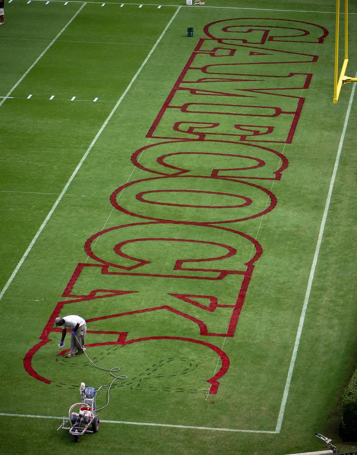 Eddie Dunning painted the end zone and mid-field graphics at Williams-Brice Stadium since 1984.