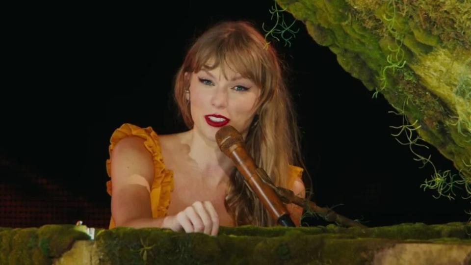 Taylor Swift speaks before playing "Champagne Problems" in "Taylor Swift: The Eras Tour" (Credit: AMC)