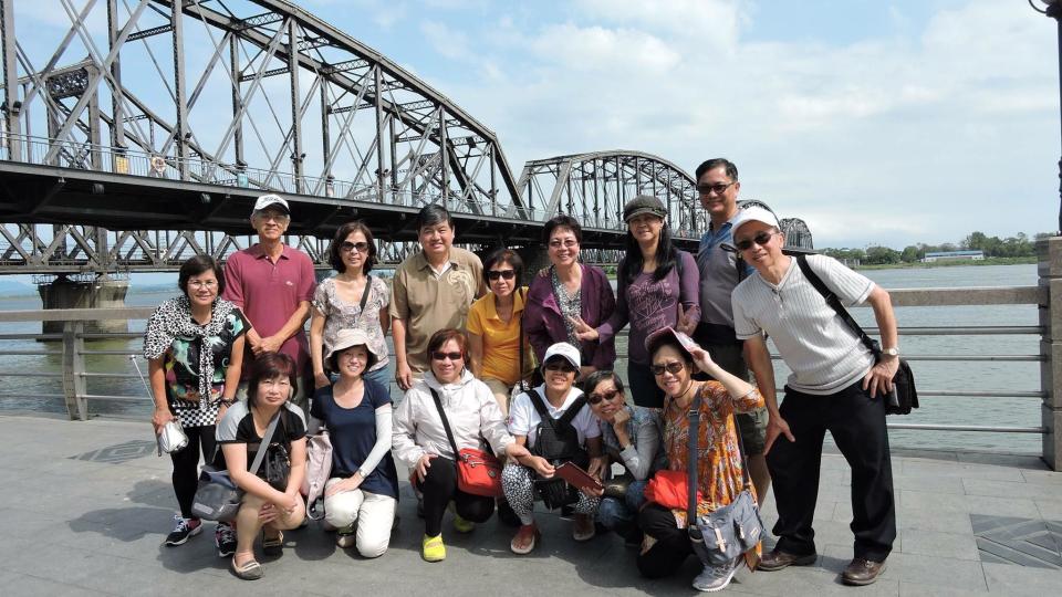 Emily Song (bottom left) and her tour group on the Chinese side of the Broken Bridge, which connects Dandong with the North Korean city of Sinuiju over the Yalu River. (PHOTO: Emily Song)