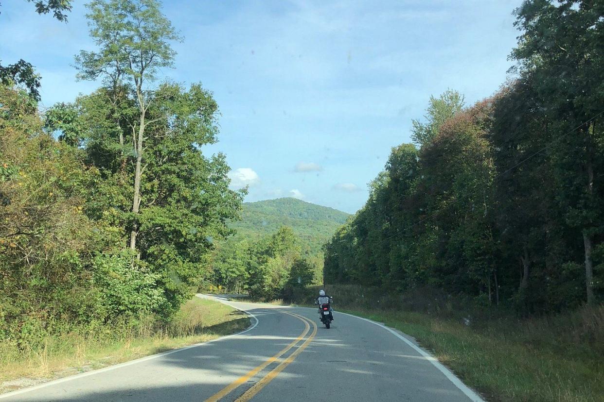 A Motorcycle Riding on the Pig Trail Scenic Byway, Arkansas, during a sunny summer day