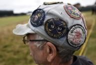 A spectator wearing a hat with golf badges watches play during a practice round ahead of the British Open Championship at the Royal Liverpool Golf Club in Hoylake, northern England July 16, 2014. REUTERS/Toby Melville (BRITAIN - Tags: SPORT GOLF)