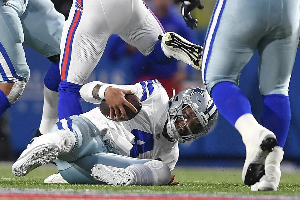 Dallas Cowboys quarterback Dak Prescott (4) hits the turf during the second quarter of an NFL football game against the Buffalo Bills, Sunday, Dec. 17, 2023, in Orchard Park, N.Y. (AP Photo/Adrian Kraus)