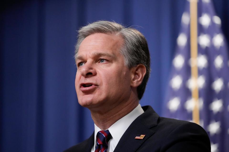 FBI Director Christopher Wray speaks during a news conference at the Department of Justice in Washington on Friday related to charges against three men in a plot to kill an Iranian American author and activist who has spoken out against human rights abuses in Iran.