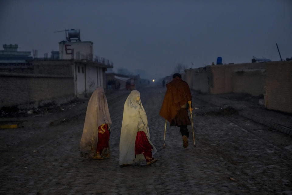 An internally displaced man who lost one of his legs during a suicide attack at the Kabul airport, walks in a camp on the outskirts of Kabul, Afghanistan, Thursday, Feb 2, 2023. (AP Photo/Ebrahim Noroozi)