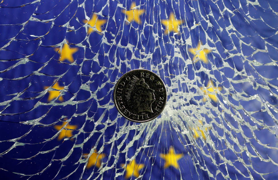 A pound coin is placed on broken glass and EU flag in this illustration picture taken January 28, 2019. Phone: REUTERS/Dado Ruvic/Illustration