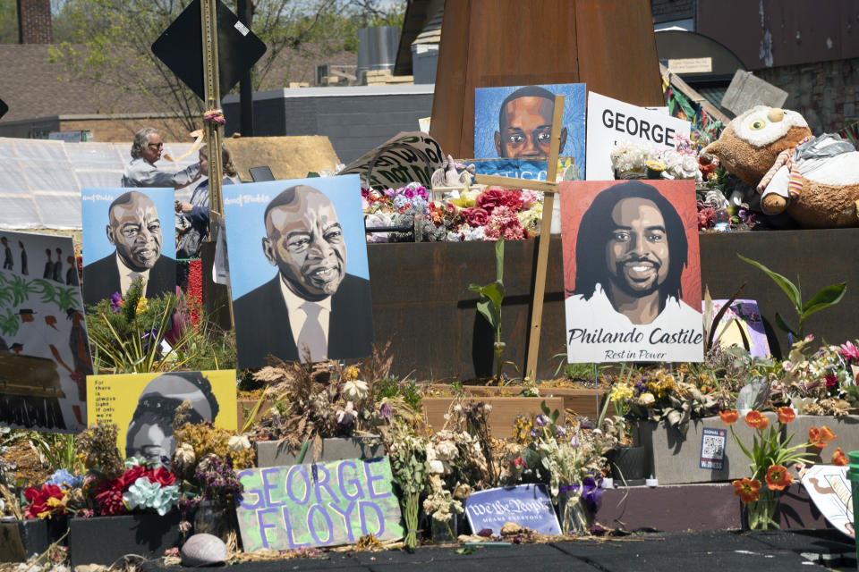 Flowers line the street at George Floyd Square in Minneapolis. Photos of other Black people killed by police officers also fill the area, located at the intersection of 38th St. and Chicago Ave. (Judy Griesedieck for Yahoo News)