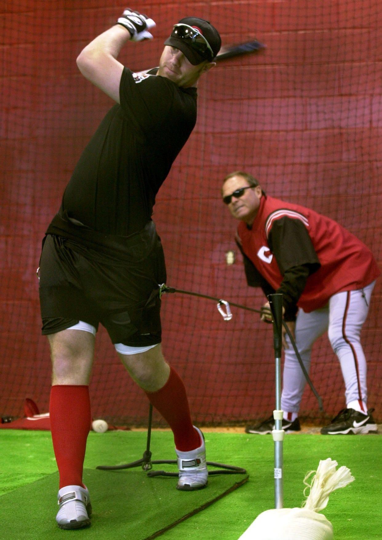 FEBRUARY 19, 2002: Adam Dunn takes batting practice while hitting coach Jim Lefebvre watches his swing during spring training at the City of Sarasota Sports Complex.