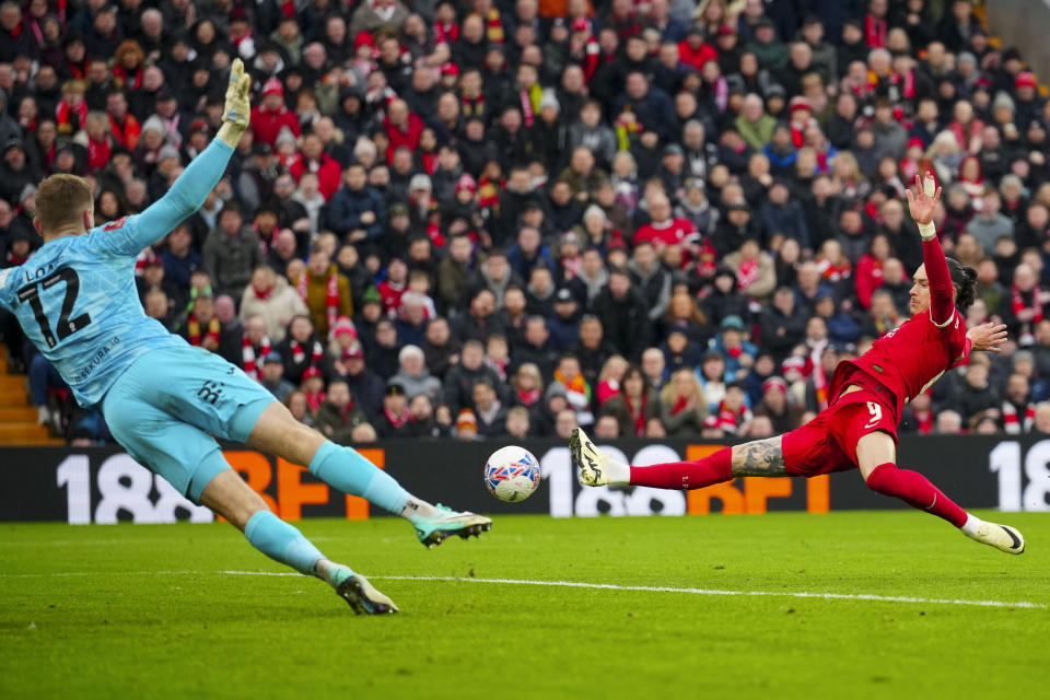 Norwich City's goalkeeper George Long, left, makes a save in front of Liverpool's Darwin Nunez during the English FA Cup fourth round soccer match between Liverpool and Norwich, at Anfield stadium in Liverpool, England, Sunday, Jan. 28, 2024. (AP Photo/Jon Super)