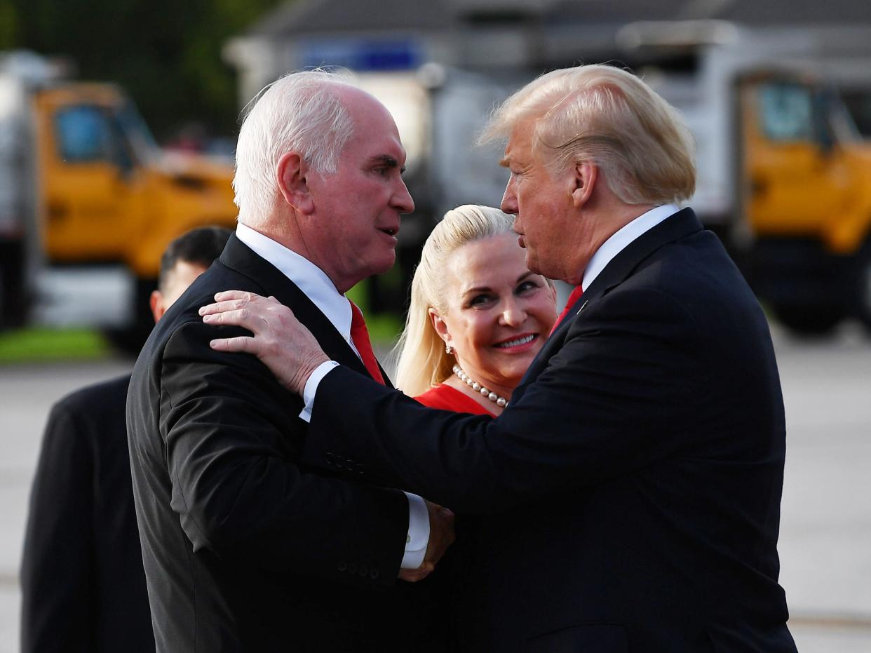 US President Donald Trump greets Rep. Mike Kelly and his wife Victoria upon arrival at Erie International Airport in Erie, Pennsylvania on October 10, 2018.