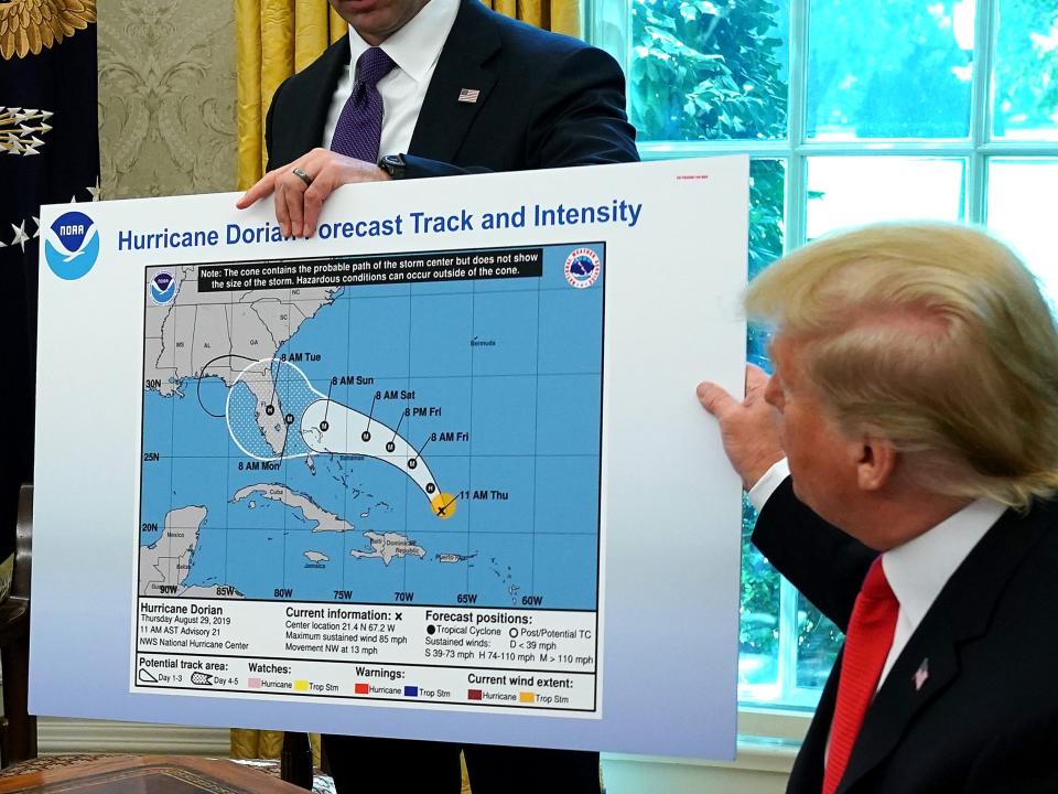 WASHINGTON, DC - SEPTEMBER 04: U.S. President Donald Trump (R) references a map held by acting Homeland Security Secretary Kevin McAleenan while talking to reporters following a briefing from officials about Hurricane Dorian in the Oval Office at the White House September 04, 2019 in Washington, DC. The map was a forecast from August 29 and appears to have been altered by a black marker to extend the hurricane's range to include Alabama.