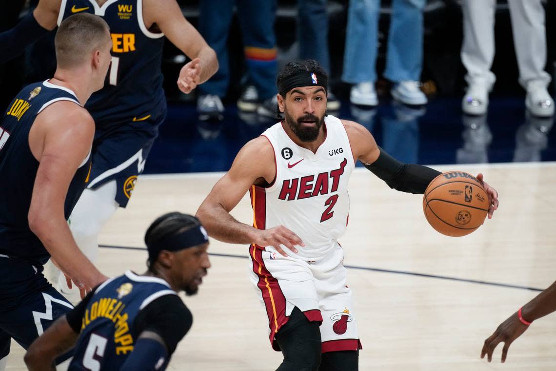 Miami Heat guard Gabe Vincent (2) moves the ball against the Denver Nuggets during the first half of Game 2 of basketball’s NBA Finals, Sunday, June 4, 2023, in Denver.
