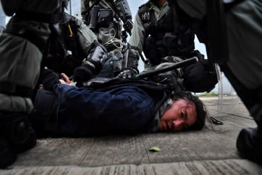 Several of the black-clad protesters were detained in Hong Kong's Kwun Tong district as officers swept through