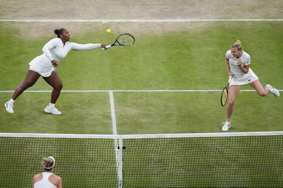 Katerina Siniakova of Czech Republic and Taylor Townsend, left, of the United States in action against Gabriela Dabrowski of Canada and Erin Routliffe of New Zealand in the women's doubles final at the Wimbledon tennis championships in London, Saturday, July 13, 2024. (AP Photo/Kirsty Wigglesworth)