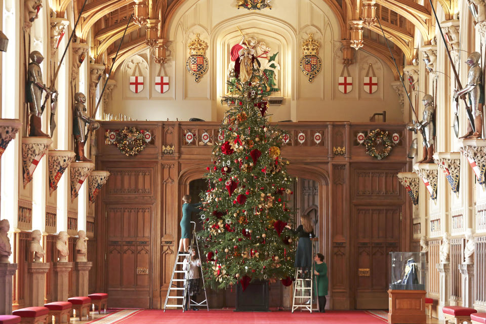 Palace staff decorate the 20ft tree in the castle's St George's Hall [Image: PA Images]