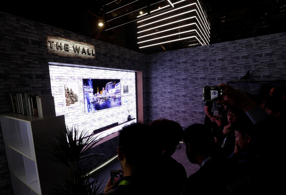 People take photos of The Wall, the world’s first consumer modular MicroLED 146-inch TV, in the Samsung Electronics booth at the Las Vegas Convention Center during the 2018 CES in Las Vegas, Nevada, U.S. January 9, 2018. REUTERS/Steve Marcus