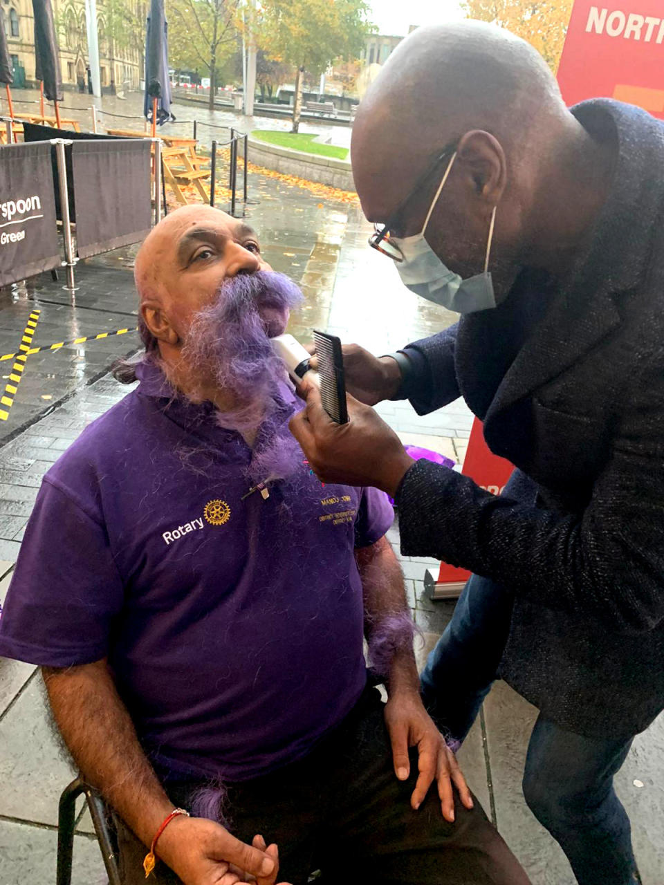 Dr Manoj Joshi, 68, shaved his moustache for the first time in 52 YEARS at Bradford City Hall to raise funds to eradicate polio. See SWNS story SWLEmoustache; A man who shaved his moustache to raise funds for a polio vaccine says his wife cant even recognise him - after he trimmed it for the first time in 52 YEARS. Dr Manoj Joshi, 68, says he had never shaved his moustache ever since he could grow one as a fresh faced 16-year-old but decided to chop it all off in a bid to eradicate polio. But after he chopped it off his shocked wife said she couldnt recognise him as shed never seen him without it in the 42 years they had been married. The grandfather-of-two joked that it would take a lawn mower to trim his luscious facial hair - which is older than the invention of the mobile phone. Dr Joshi, a proud Rotarian, which is a worldwide charitable society with over a million members worldwide, has been involved in what he calls acts of giving for his entire life. On World Polio Day (Saturday, Oct 24) he took centre stage at a park in front of Bradford City Hall to shave off his beloved moustache in an emotional day.