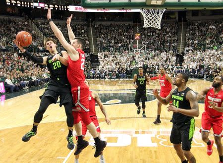 Feb 17, 2019; East Lansing, MI, USA; Michigan State Spartans guard Matt McQuaid (20) is defended by Ohio State Buckeyes forward Kyle Young (25) during the first half of a game at the Breslin Center. Mandatory Credit: Mike Carter-USA TODAY Sports