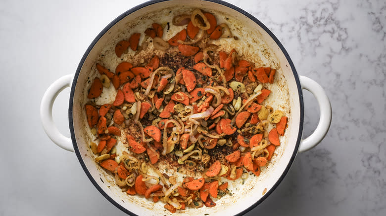 flour coated veggies in Dutch oven