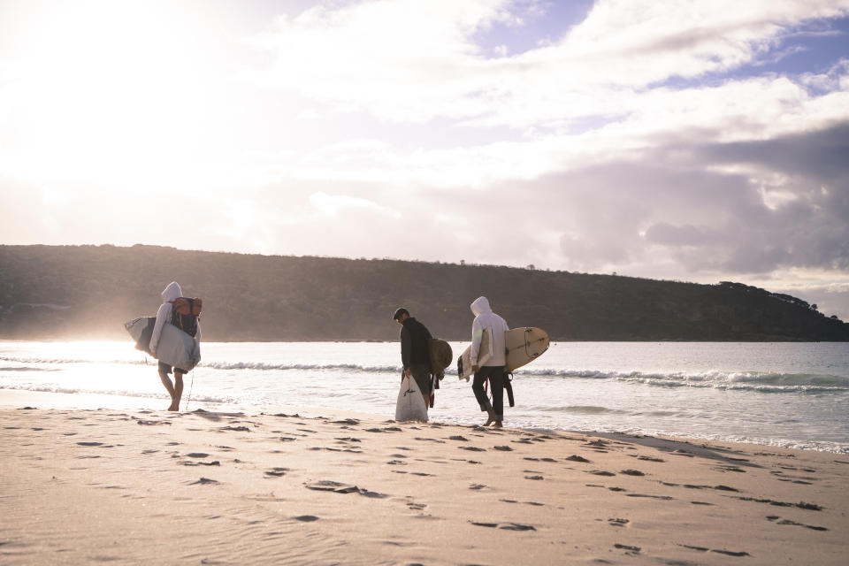 Surfers walk along the beach at Bunker Bay, 2.5 hours south of Perth in the Margaret River region of Western Australia. Source: AAP