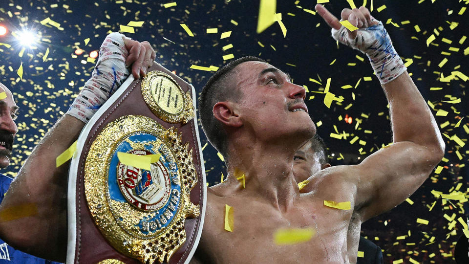 Tim Tszyu holds up his belt and celebrates after defeating Tony Harrison.