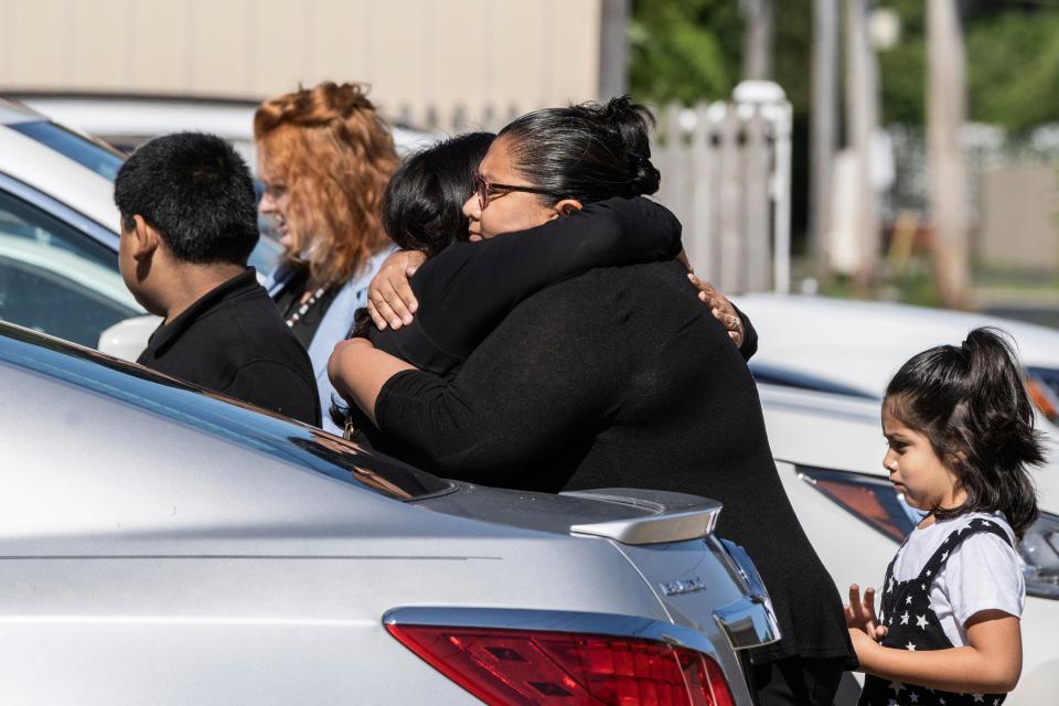 Mourners hug outside Memorial Chapel Funeral Home in Waukegan, Ill., during funeral services for Eduardo Uvaldo, who was killed Monday during a mass shooting at the Fourth of July parade in Highland Park, Saturday, July 9, 2022.