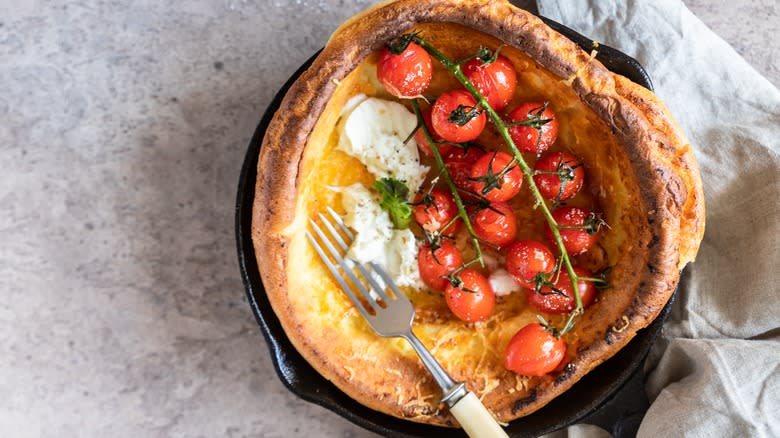 Dutch baby topped with tomatoes