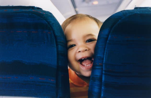 Here's how to make flights with kids less stressful, according to parents. (Photo: Charles Gullung via Getty Images)