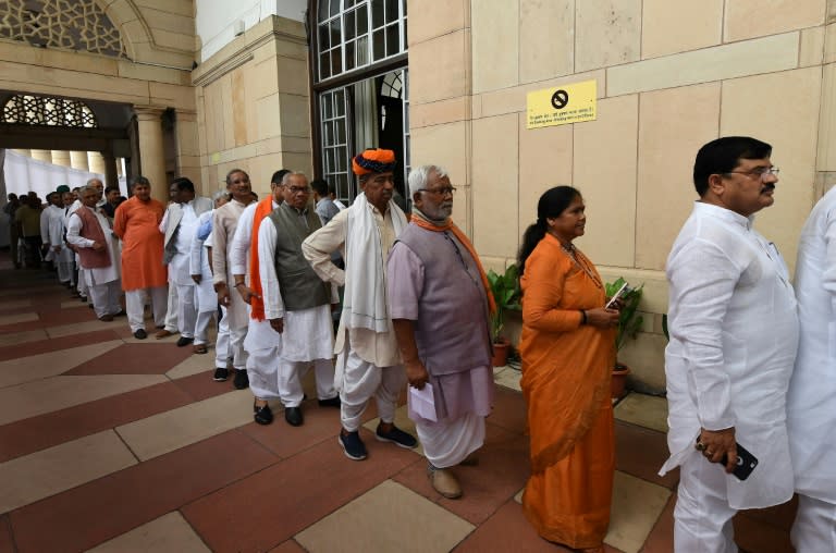 Indian members of parliament queue to cast their votes for the next president at Parliament House in New Delhi