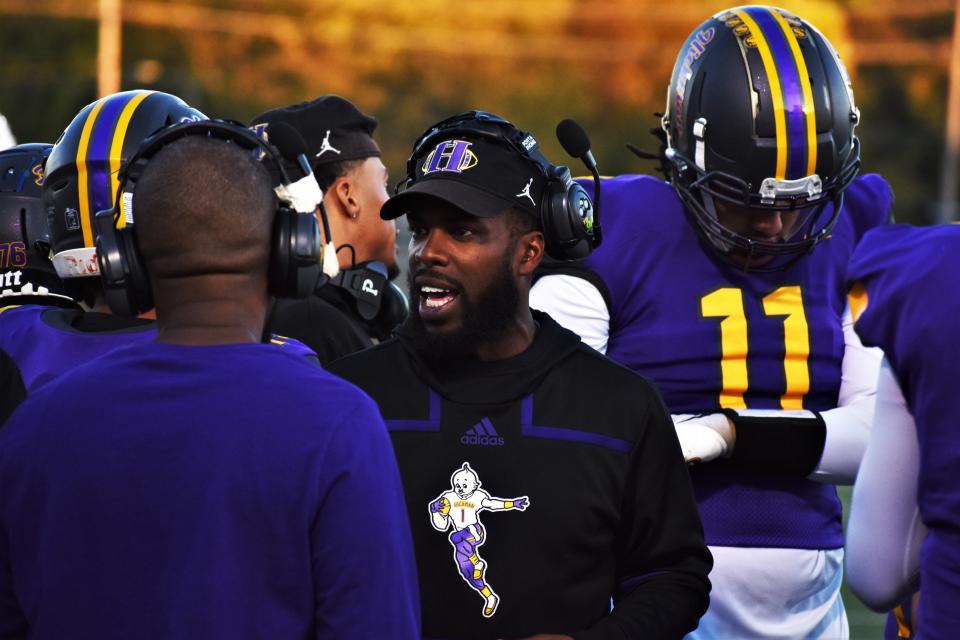Hickman head coach Cedric Alvis talks to his staff during Hickman's game against Belleville West at Hickman High School on Oct. 20, 2023, in Columbia, Mo.