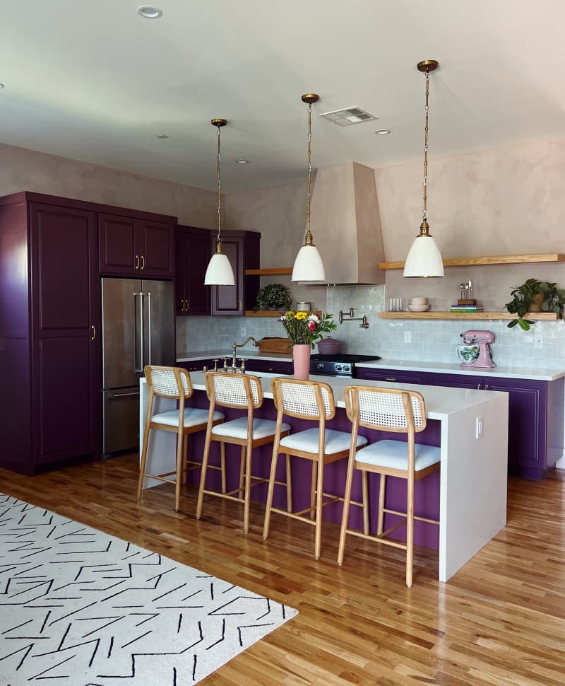 Eggplant painted cabinets in kitchen with light pink painted walls