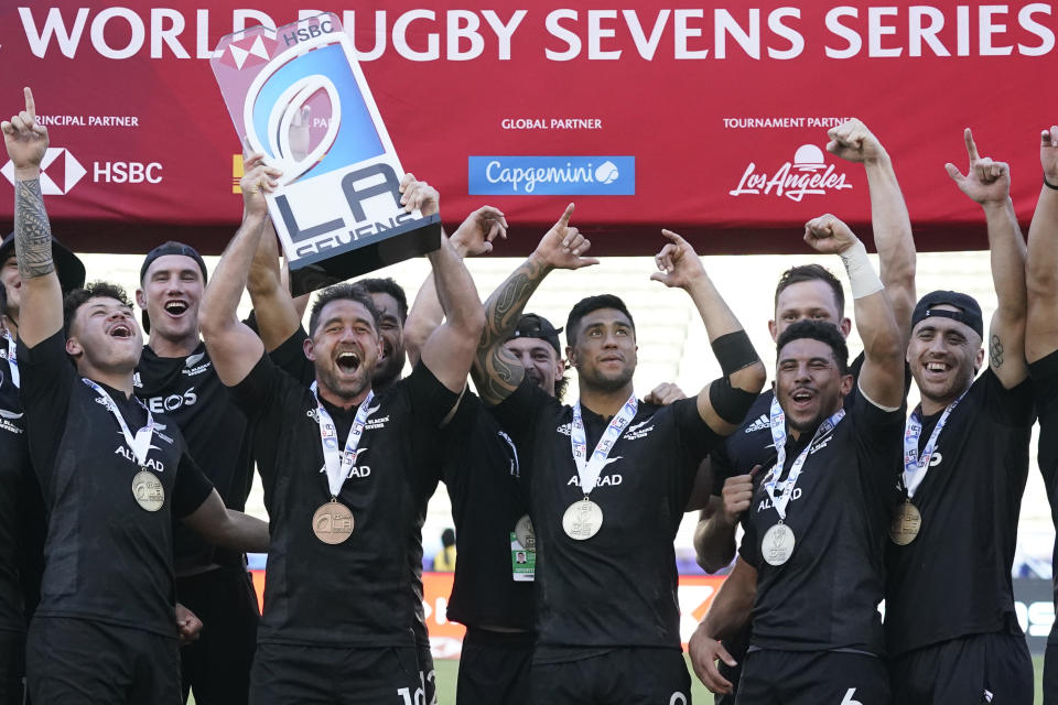 New Zealand's Kurt Baker and members of the team lift the trophy for winning the Los Angeles rugby sevens series final match between Fiji and New Zealand at Dignity Health Sports Park in Carson, Calif., Sunday, 28, Aug. 27, 2022. (AP Photo/Marcio Jose Sanchez)