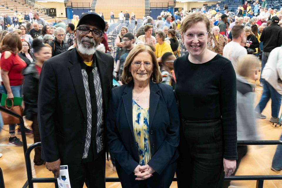 From left, Topeka JUMP co-chair Rev. Curtis Odum, Pastor Lorna Boden and lead organizer Sarah Balzer stand on stage following Monday's Nehemiah Action event at Lee Arena.