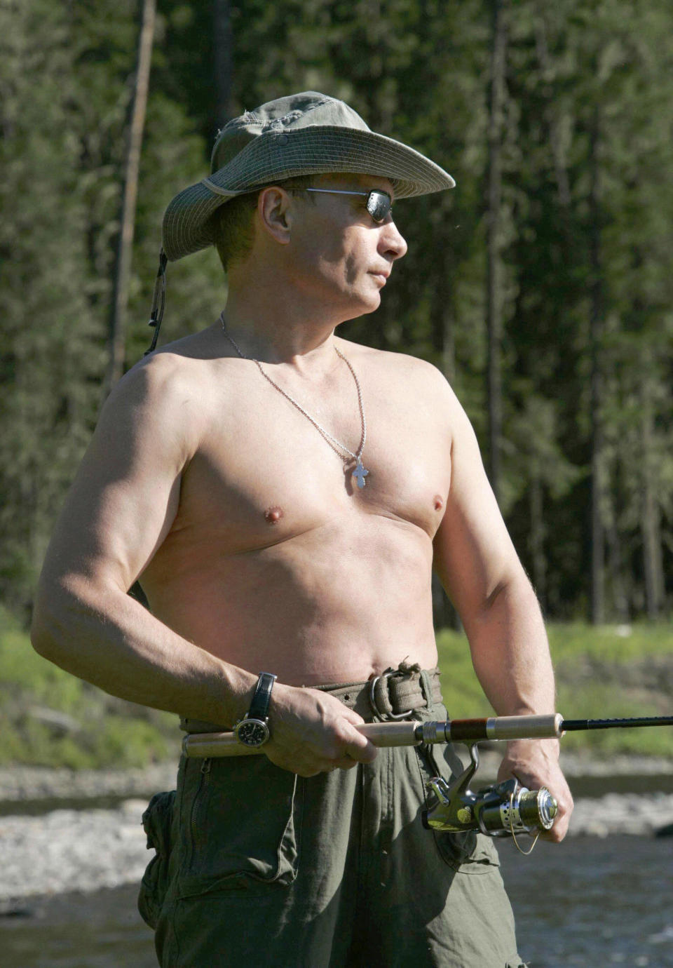 FILES - Picture taken 13 August 2007 shows Russian President Vladimir Putin fishing in the headwaters of the Yenisei River of the Russian Tuva republic on the border of Mongolia. Time magazine named President Vladimir Putin its 'person of the year' 19 December 2007 in recognition of the Russian leader's role in making Moscow 'a critical linchpin of the 21st century. The award, which is not considered an honor so much as a recognition of the most powerful forces shaping the world, was awarded for Putin's role in reshaping a country that Time's Managing Editor Richard Stengel said had 'fallen off our mental map.'       AFP PHOTO / RIA NOVOSTI / KREMLIN POOL / DMITRY ASTAKHOV (Photo credit should read DMITRY ASTAKHOV/AFP/Getty Images)