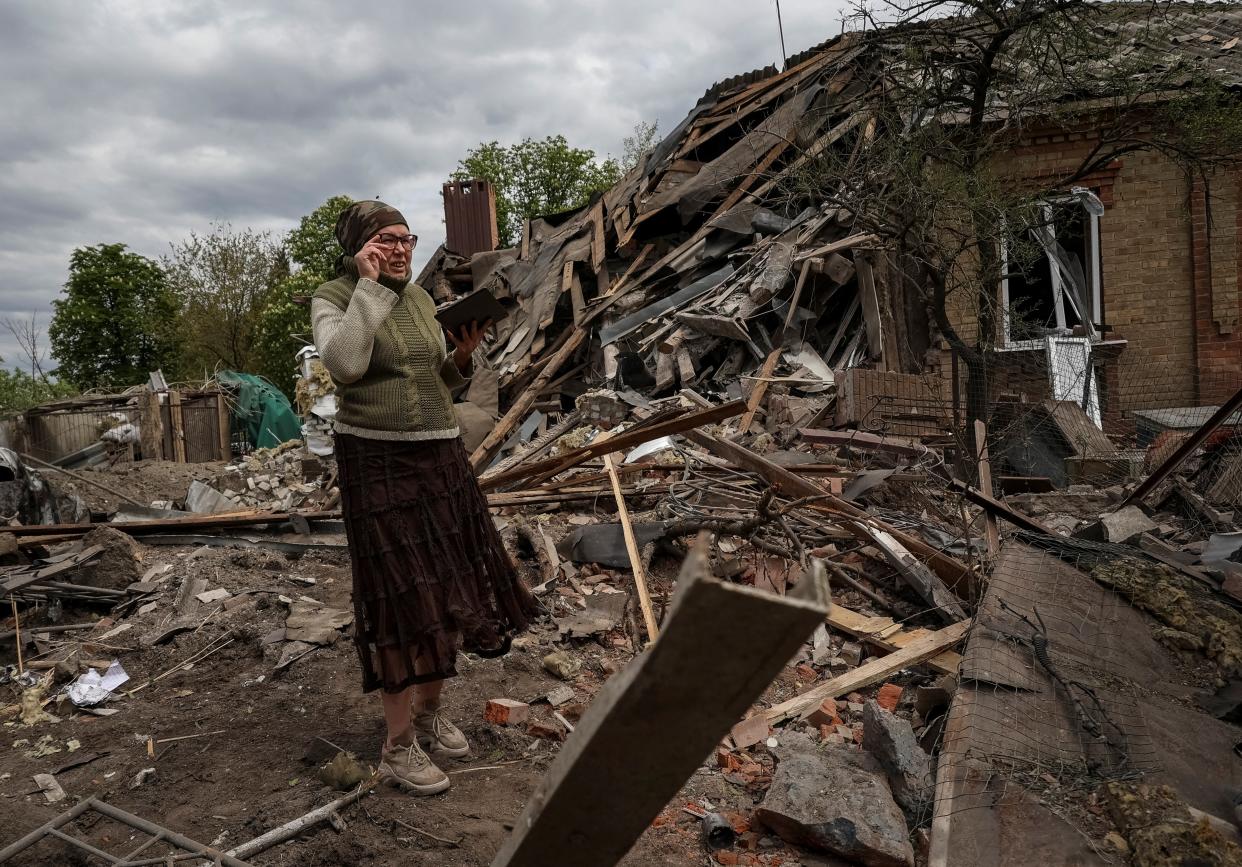 A local resident stands among remains of a house in a yard, hit by a Russian military strike, amid Russia's attack on Ukraine, in Sloviansk, Donetsk region (REUTERS)