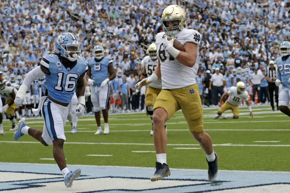 Notre Dame tight end Michael Mayer (87) goes past North Carolina defensive back DeAndre Boykins (16) for a touchdown during the first half of an NCAA college football game in Chapel Hill, N.C., Saturday, Sept. 24, 2022 (AP Photo/Chris Seward)