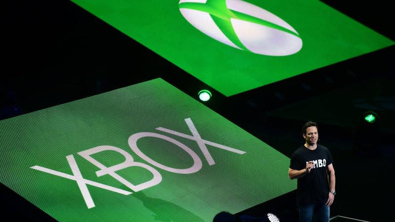 Microsoft Gaming CEO Phil Spencer stands in front of giant Xbox logos.