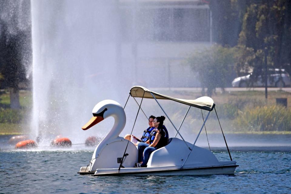 People take a boat ride at Echo Park on Aug. 30