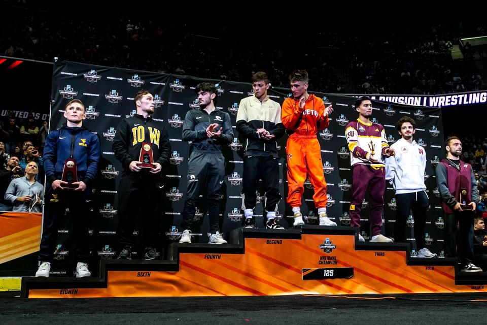 Iowa's Spencer Lee, second from left, stands on the podium for 125 pounds after Princeton's Pat Glory beat Purdue's Matt Ramos in the finals during the sixth session of the NCAA Division I Wrestling Championships, Saturday, March 18, 2023, at BOK Center in Tulsa, Okla.