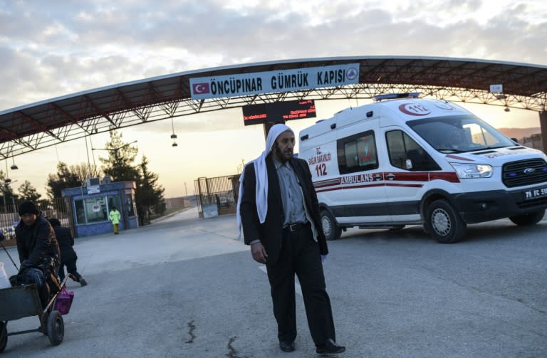 An ambulance carrying an injured person, crosses the Syrian-Turkish border at the Oncupinar crossing gate, near the town of Kilis, in south-central Turkey, on February 10, 2016