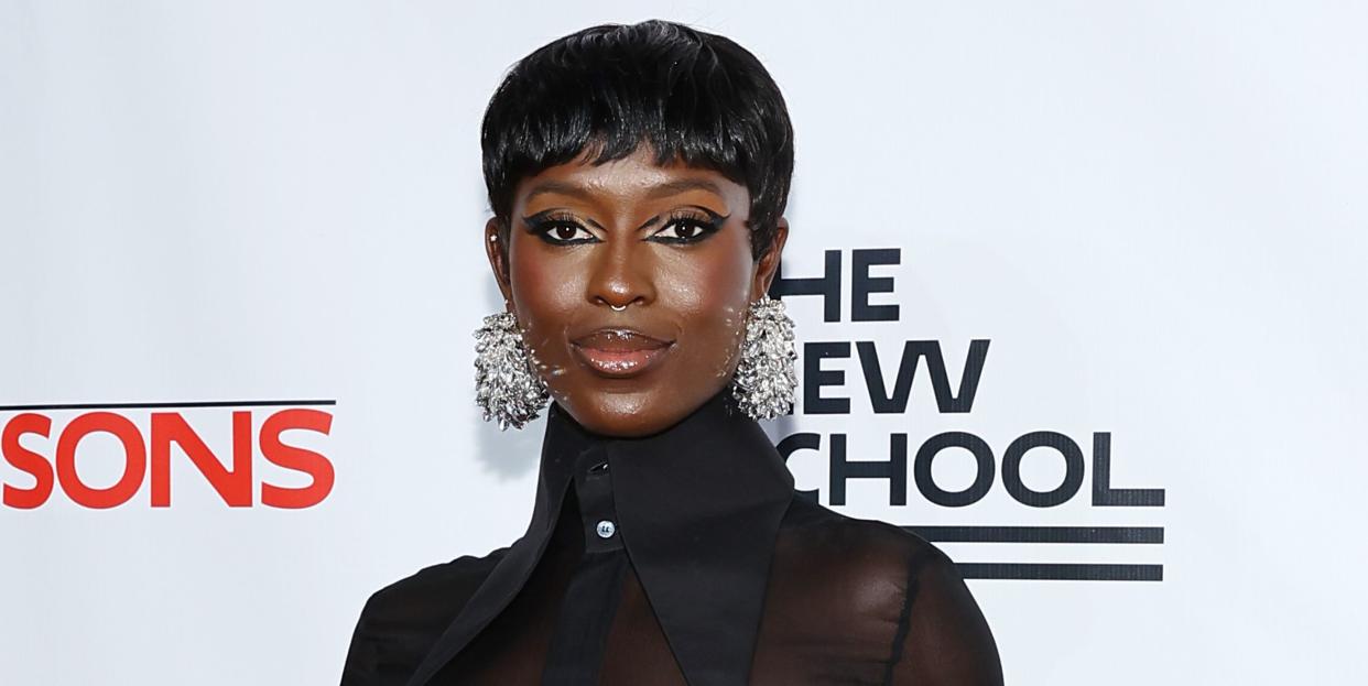 jodie turner smith smiles on red carpet in an all black outfit