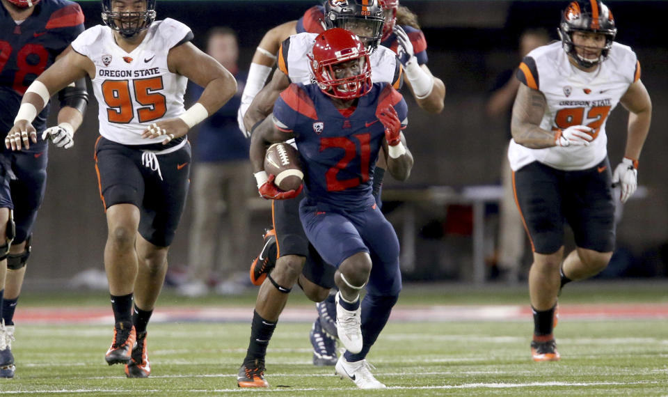 Arizona running back J.J. Taylor (21) leaves the Oregon State defense behind on a long run during the second quarter of an NCAA college football game Saturday, Nov. 11, 2017, Tucson, Ariz. (Kelly Presnell/Arizona Daily Star via AP)