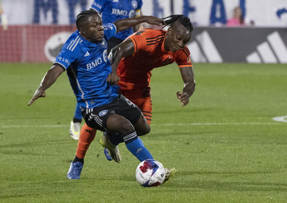 CF Montreal forward Chinonso Offor, left, and Houston Dynamo midfielder Luis Caicedo vie for the ball during the first half of an MLS soccer match Wednesday, Oct. 4, 2023, in Montreal. (Christinne Muschi/The Canadian Press via AP)