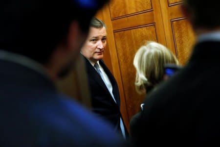 U.S. Senator Ted Cruz (R-TX) speaks with reporters as he walks to the Senate floor between votes on procedural measures leading up to potential tax overhaul legislation at the U.S. Capitol in Washington, U.S., December 1, 2017. REUTERS/Jonathan Ernst