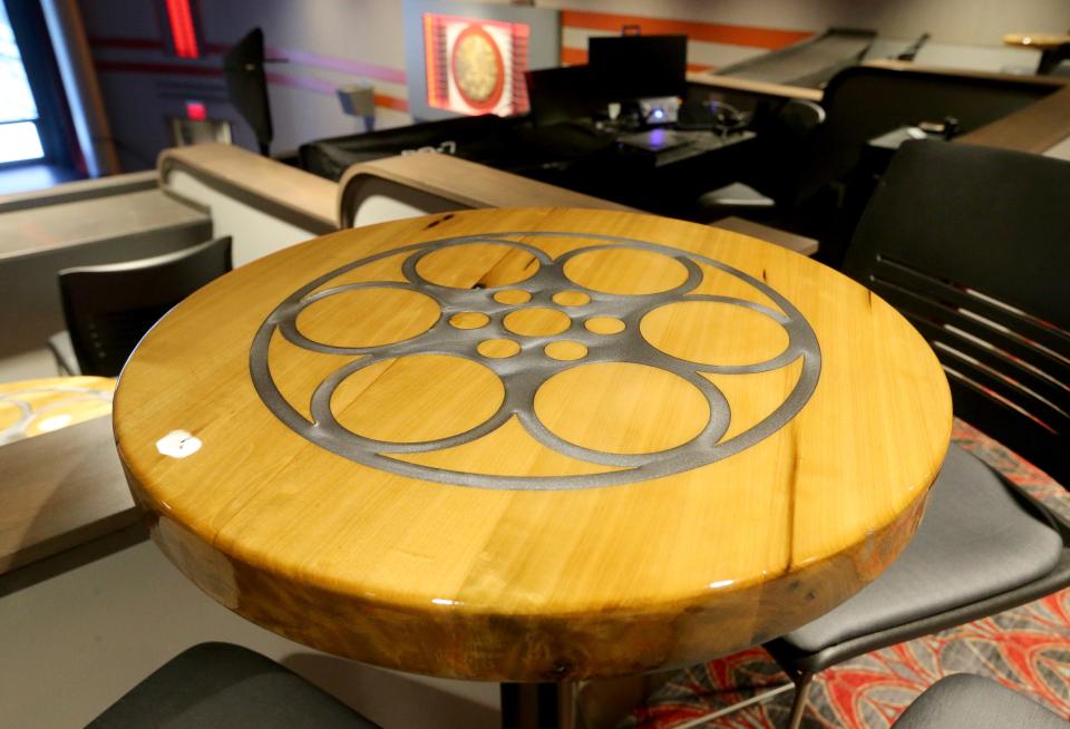 Tables made from 1865 wood from the original structures in the theater are in the balcony Friday, Dec. 2, 2022, at The Rees in downtown Plymouth.