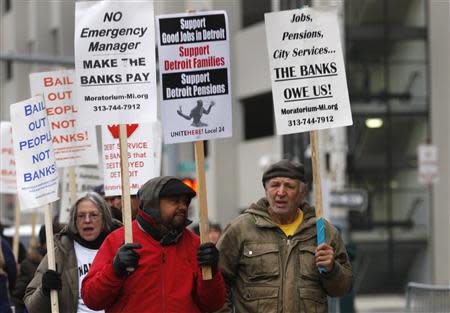 Protesters rally outside the Detroit Federal Court House during a bankruptcy hearing declaring Detroit is eligible for the biggest municipal bankruptcy in U.S. history, in Detroit, Michigan December 3, 2013. REUTERS/Rebecca Cook
