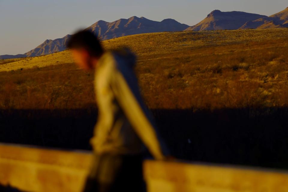 A migrant travels on a train on the outskirts of Ciudad Juarez (Reuters)