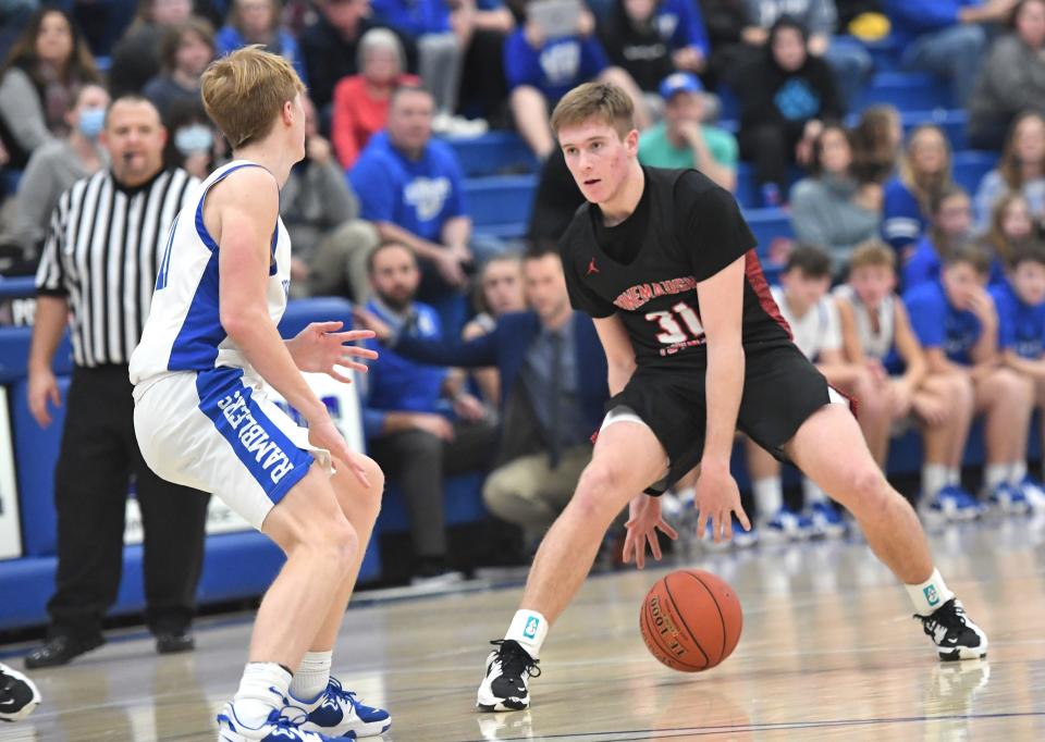 Conemaugh Township's Jackson Byer (31) looks to drive on Windber's Caden Dusack during a WestPAC boys basketball contest, Thursday, in Windber.