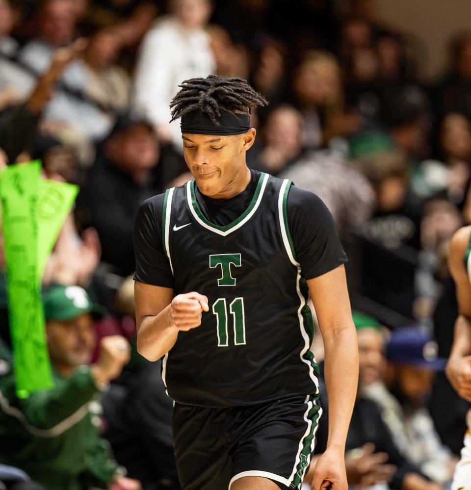 Trinity's Jayden Johnson (11) pumped his fist after hitting a shot as the Trinity Shamrocks faced off against rival St. Xavier Tigers at Knights Hall on the Bellarmine campus on Friday night. Trinity defeated St. Xavier, 81-59. Jan. 26, 2024