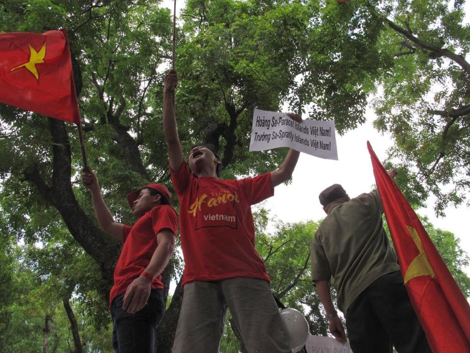 Vietnamese protest outside the Chinese Embassy on Sunday, May 11, 2014 in Hanoi, Vietnam, against Beijing's deployment of an oil rig in the contested waters of the South China Sea. The deployment of the rig has a triggered a tense standoff in the ocean and raised fears of confrontation between the neighboring countries. The banner reads "Hoang Sa is the vietnames term for the the Paracel Islands, Truong Sa is the Vietnamese term for the Spratly Islands." (AP Photo/Chris Brummitt)